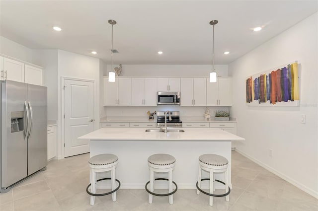 10995 Pinot Dr, Venice, FL 34293 - kitchen featuring a sink, stainless steel appliances, a center island with sink, white cabinetry, and light countertops