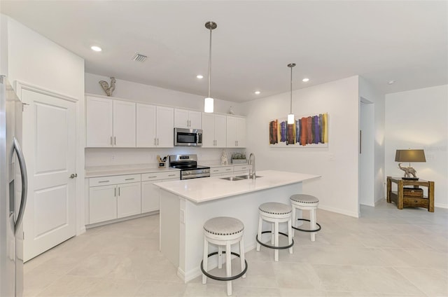 10995 Pinot Dr, Venice, FL 34293 - kitchen featuring visible vents, white cabinets, appliances with stainless steel finishes, and a sink