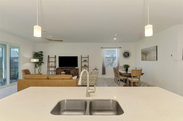 10995 Pinot Dr, Venice, FL 34293 - kitchen featuring a sink, open floor plan, pendant lighting, and light tile patterned floors