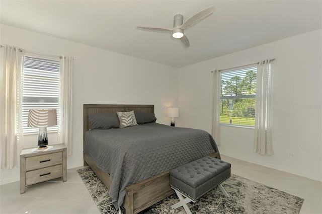 10995 Pinot Dr, Venice, FL 34293 - bedroom featuring light tile patterned floors, baseboards, and a ceiling fan