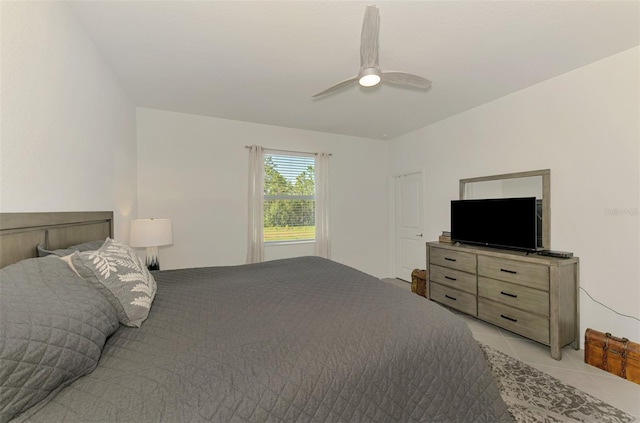 10995 Pinot Dr, Venice, FL 34293 - bedroom with light tile patterned floors and a ceiling fan