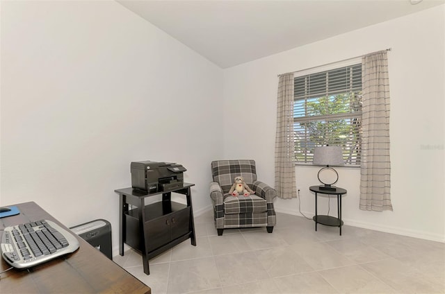 10995 Pinot Dr, Venice, FL 34293 - living area with vaulted ceiling, baseboards, and tile patterned flooring