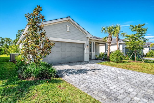 10995 Pinot Dr, Venice, FL 34293 - ranch-style house with a front lawn, central air condition unit, an attached garage, and decorative driveway