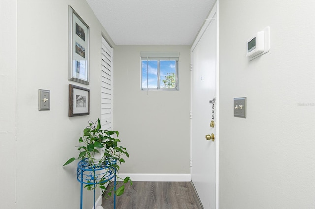 22375 Edgewater Dr Unit 123, Punta Gorda, FL 33980 - hall featuring a textured ceiling, baseboards, and wood finished floors