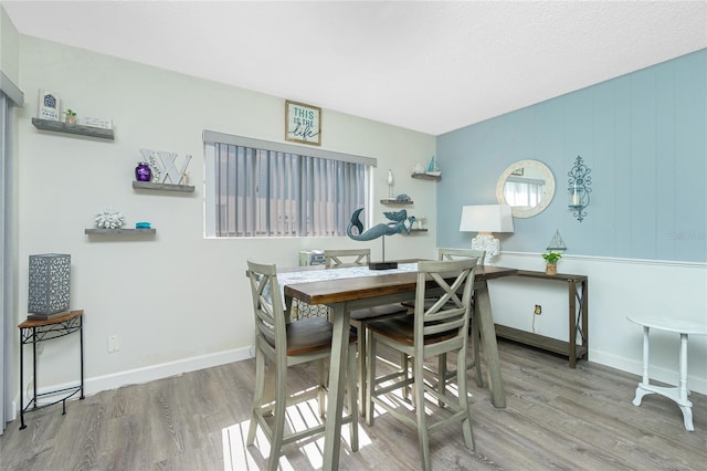 22375 Edgewater Dr Unit 123, Punta Gorda, FL 33980 - dining area featuring baseboards and wood finished floors