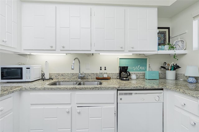 22375 Edgewater Dr Unit 123, Punta Gorda, FL 33980 - kitchen featuring white cabinetry, white appliances, light stone counters, and a sink
