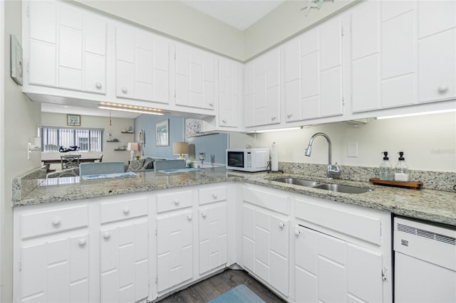 22375 Edgewater Dr Unit 123, Punta Gorda, FL 33980 - kitchen with a sink, white cabinets, dark wood finished floors, light stone countertops, and white appliances
