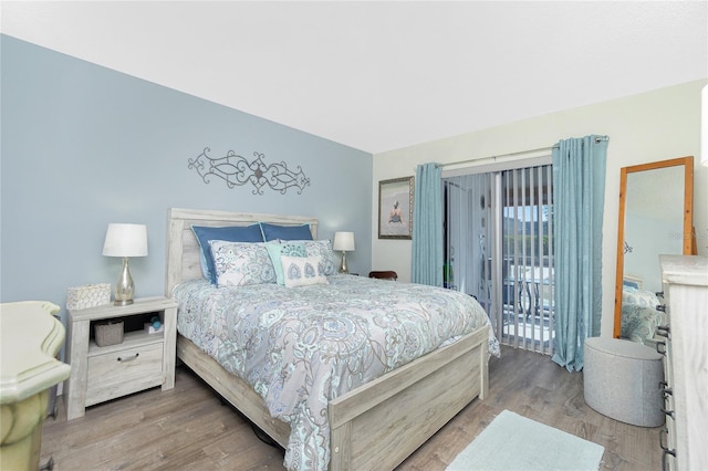 22375 Edgewater Dr Unit 123, Punta Gorda, FL 33980 - bedroom with wood finished floors and access to exterior