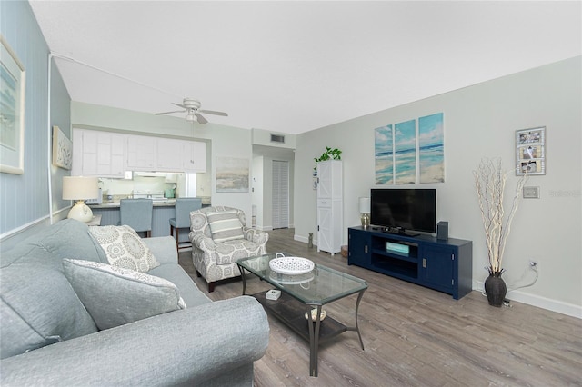 22375 Edgewater Dr Unit 123, Punta Gorda, FL 33980 - living area with baseboards, visible vents, a ceiling fan, and wood finished floors