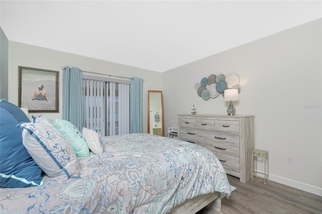 22375 Edgewater Dr Unit 123, Punta Gorda, FL 33980 - bedroom with baseboards and wood finished floors