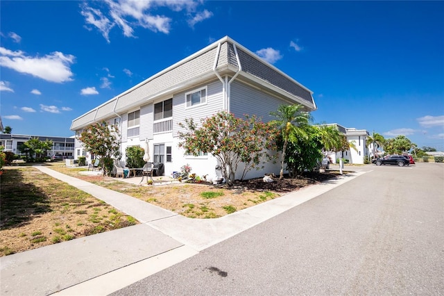 22375 Edgewater Dr Unit 123, Punta Gorda, FL 33980 - view of property exterior with mansard roof