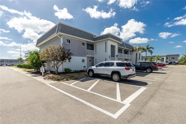 22375 Edgewater Dr Unit 123, Punta Gorda, FL 33980 - view of front of home featuring uncovered parking, roof with shingles, and mansard roof