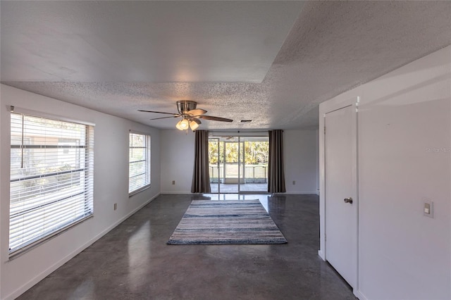 320 W Ann St, Punta Gorda, FL 33950 - empty room featuring baseboards, concrete flooring, ceiling fan, and a textured ceiling