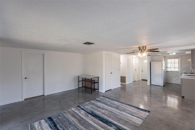 320 W Ann St, Punta Gorda, FL 33950 - spare room with a textured ceiling, concrete flooring, a ceiling fan, and visible vents