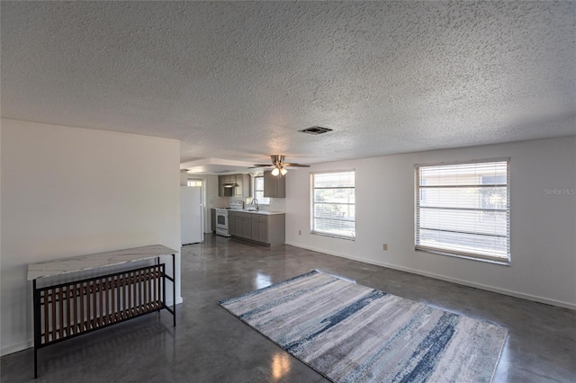 320 W Ann St, Punta Gorda, FL 33950 - living area featuring finished concrete floors, a textured ceiling, ceiling fan, and visible vents