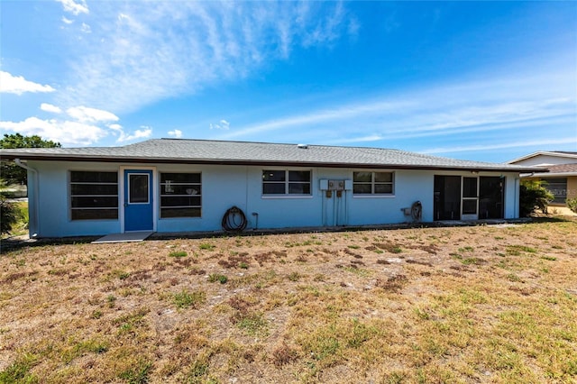 320 W Ann St, Punta Gorda, FL 33950 - rear view of property featuring a lawn, stucco siding, and a sunroom