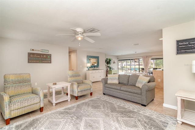 2331 Cannolot Blvd, Port Charlotte, FL 33948 - living area with light tile patterned floors, ceiling fan, and baseboards