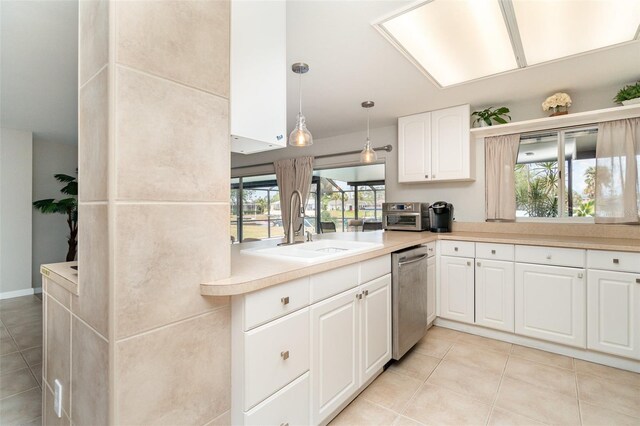 2331 Cannolot Blvd, Port Charlotte, FL 33948 - kitchen featuring dishwasher, a sink, light tile patterned floors, and light countertops