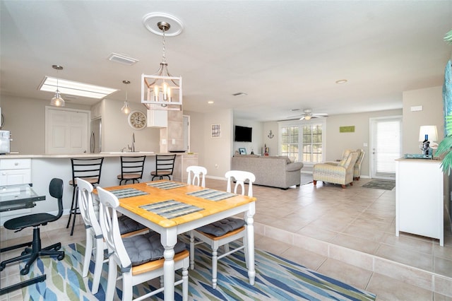 2331 Cannolot Blvd, Port Charlotte, FL 33948 - dining area with light tile patterned floors, a ceiling fan, a chandelier, and baseboards