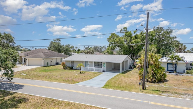 2331 Cannolot Blvd, Port Charlotte, FL 33948 - ranch-style home with driveway, a front lawn, an attached carport, and a porch
