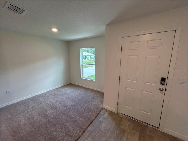 70 Karas Trl, Palm Coast, FL 32164 - spare room with carpet, baseboards, visible vents, and wood finished floors