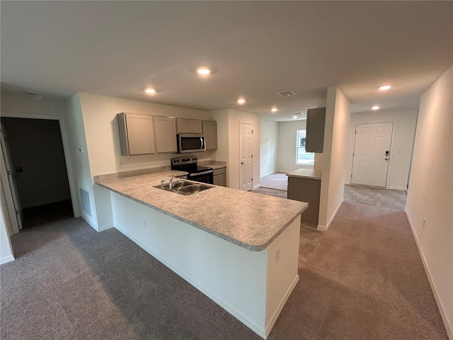 70 Karas Trl, Palm Coast, FL 32164 - kitchen featuring gray cabinetry, carpet flooring, a sink, light countertops, and appliances with stainless steel finishes