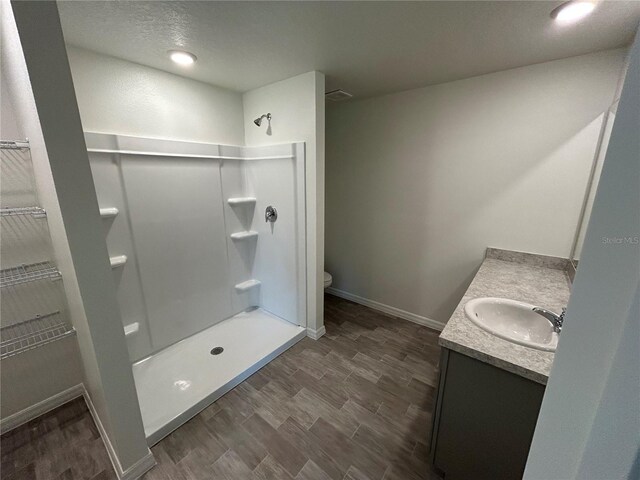 70 Karas Trl, Palm Coast, FL 32164 - bathroom featuring toilet, baseboards, a shower stall, vanity, and a spacious closet