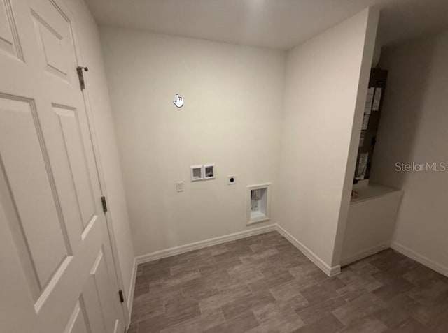 laundry area with hookup for an electric dryer, baseboards, and hookup for a washing machine