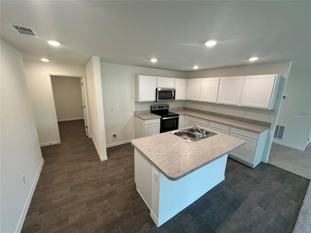 17 Luther Dr, Palm Coast, FL 32137 - kitchen with stainless steel microwave, range with electric cooktop, a sink, baseboards, and white cabinetry