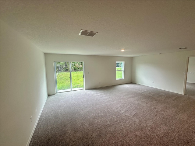 17 Luther Dr, Palm Coast, FL 32137 - carpeted spare room with baseboards and a textured ceiling