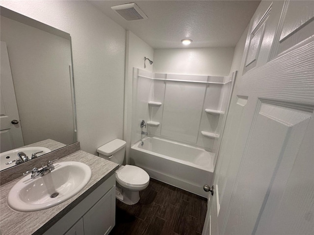 17 Luther Dr, Palm Coast, FL 32137 - bathroom with wood finished floors, toilet, vanity, shower / washtub combination, and a textured ceiling