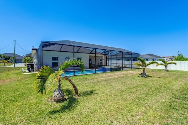 1443 SW 1st St, Cape Coral, FL 33991 - rear view of property with a pool with connected hot tub and glass enclosure