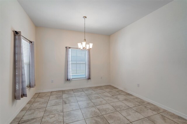 1443 SW 1st St, Cape Coral, FL 33991 - unfurnished room featuring a chandelier, light tile patterned floors, and baseboards