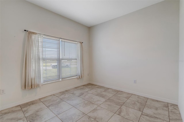 1443 SW 1st St, Cape Coral, FL 33991 - empty room with light tile patterned floors and baseboards