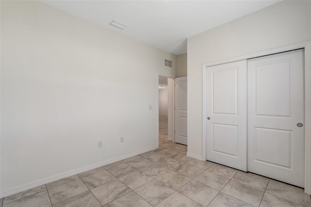 1443 SW 1st St, Cape Coral, FL 33991 - unfurnished bedroom with light tile patterned floors, a closet, and baseboards
