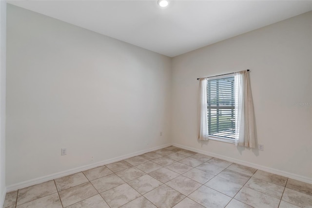 1443 SW 1st St, Cape Coral, FL 33991 - unfurnished room with light tile patterned floors and baseboards