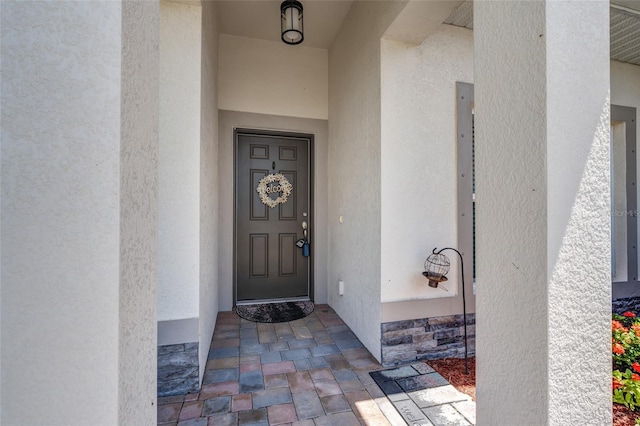 1443 SW 1st St, Cape Coral, FL 33991 - doorway to property with stucco siding