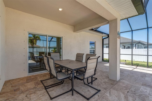 1443 SW 1st St, Cape Coral, FL 33991 - view of patio featuring outdoor dining space, glass enclosure, and fence