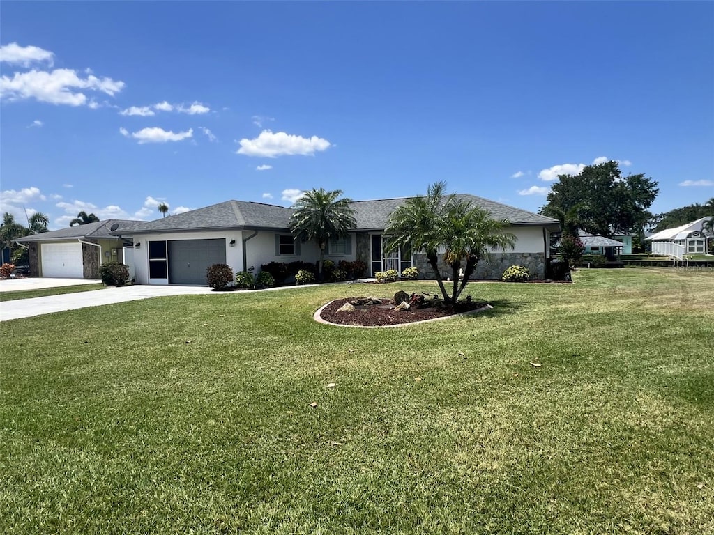 ranch-style house with concrete driveway, a garage, stucco siding, and a front yard