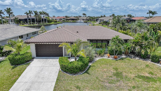 376 Portofino Dr, Punta Gorda, FL 33950 - mediterranean / spanish home with a tiled roof, a residential view, an attached garage, a water view, and a front yard