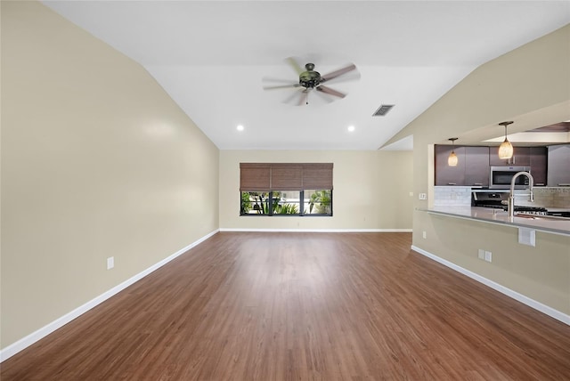376 Portofino Dr, Punta Gorda, FL 33950 - unfurnished living room featuring vaulted ceiling, ceiling fan, wood finished floors, a sink, and baseboards