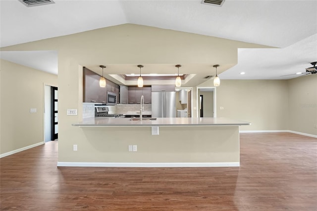 376 Portofino Dr, Punta Gorda, FL 33950 - kitchen featuring appliances with stainless steel finishes, a sink, wood finished floors, a peninsula, and tasteful backsplash