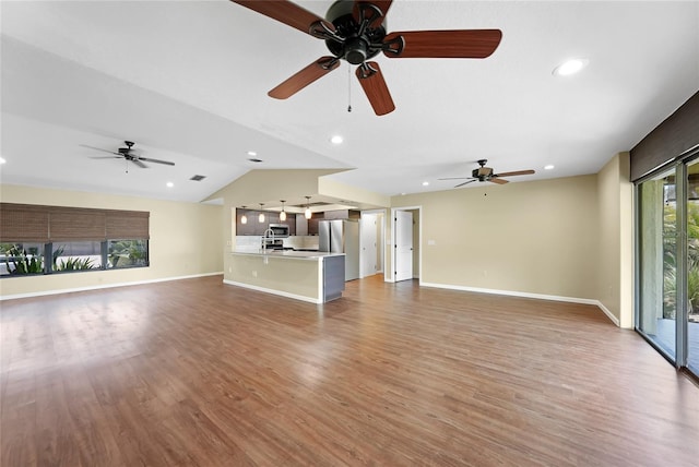 376 Portofino Dr, Punta Gorda, FL 33950 - unfurnished living room with light wood-style floors, a ceiling fan, baseboards, vaulted ceiling, and recessed lighting