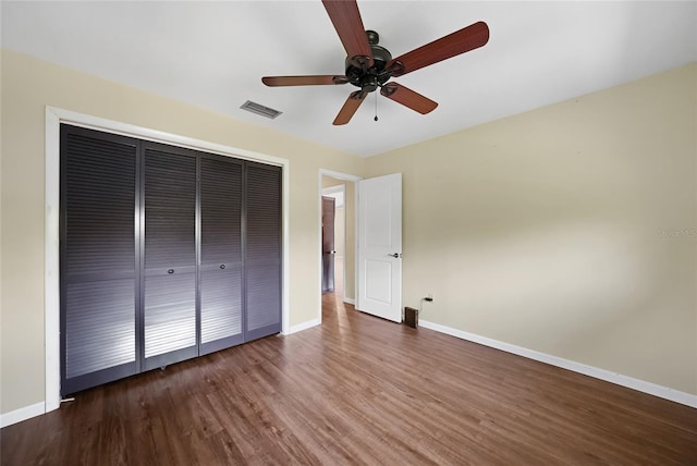 376 Portofino Dr, Punta Gorda, FL 33950 - unfurnished bedroom featuring a closet, baseboards, wood finished floors, and a ceiling fan