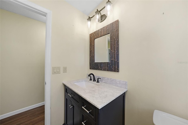 376 Portofino Dr, Punta Gorda, FL 33950 - half bathroom featuring toilet, vanity, wood finished floors, and baseboards