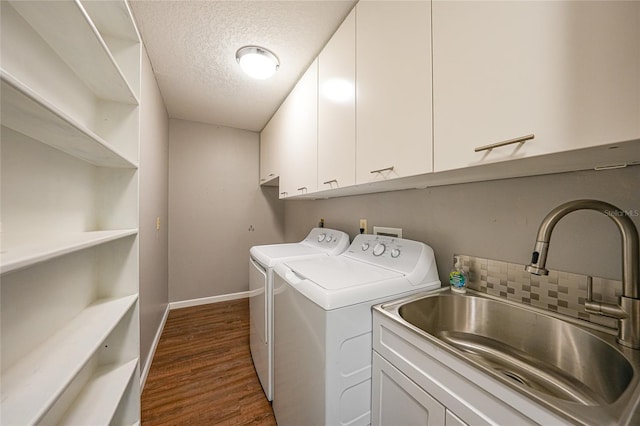 376 Portofino Dr, Punta Gorda, FL 33950 - laundry area featuring washing machine and clothes dryer, cabinet space, dark wood-style flooring, a textured ceiling, and baseboards