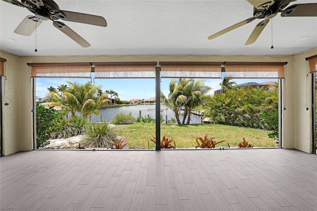 376 Portofino Dr, Punta Gorda, FL 33950 - unfurnished sunroom with a water view and wood finished floors