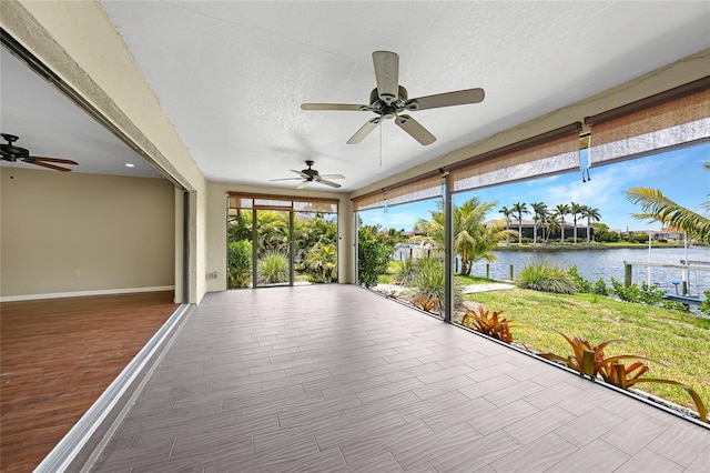 376 Portofino Dr, Punta Gorda, FL 33950 - unfurnished sunroom featuring a water view, baseboards, and a textured ceiling