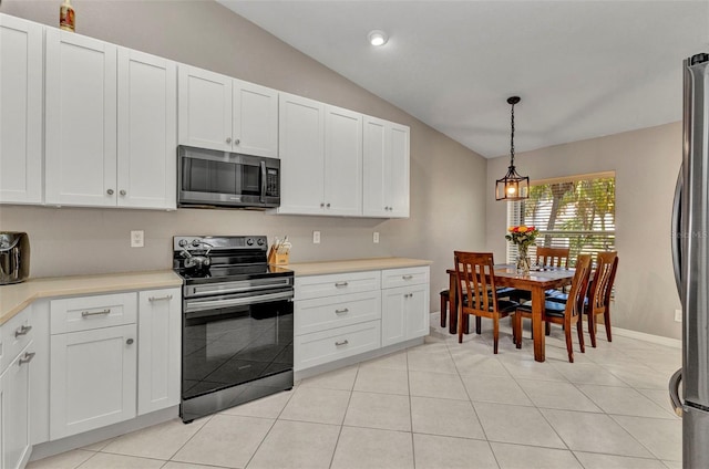 kitchen with lofted ceiling, white cabinetry, light countertops, and appliances with stainless steel finishes