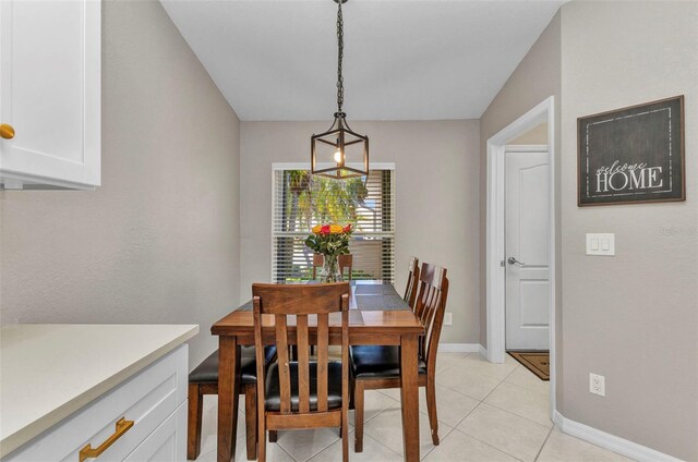 dining space with baseboards and light tile patterned floors